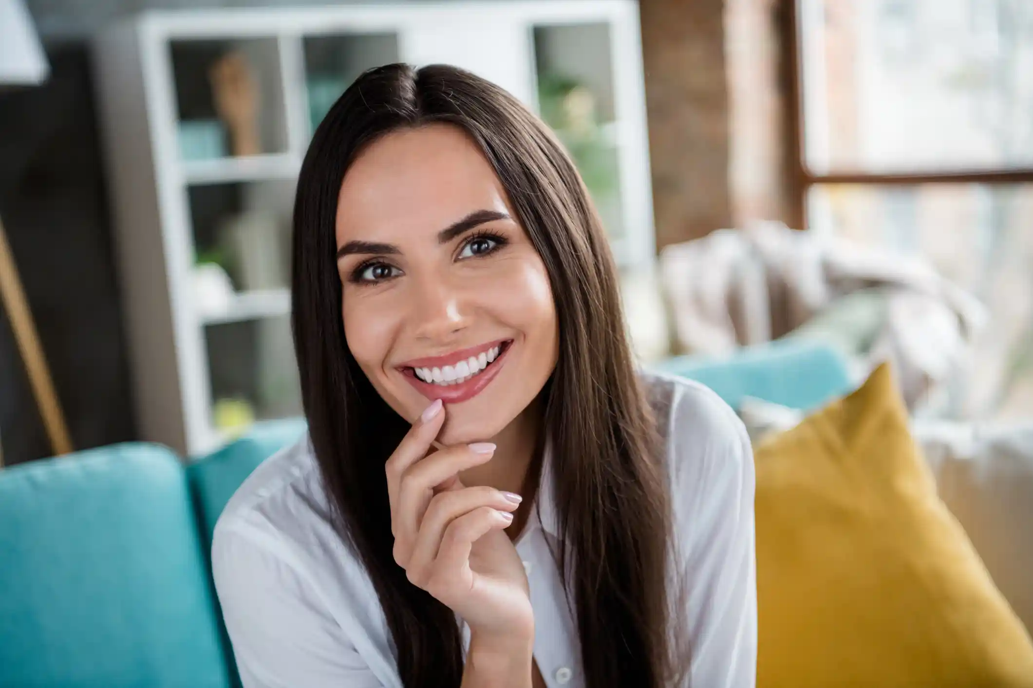 Portrait of pretty peaceful young lady beaming smile arm fingers touch chin good mood spend pastime apartment inside